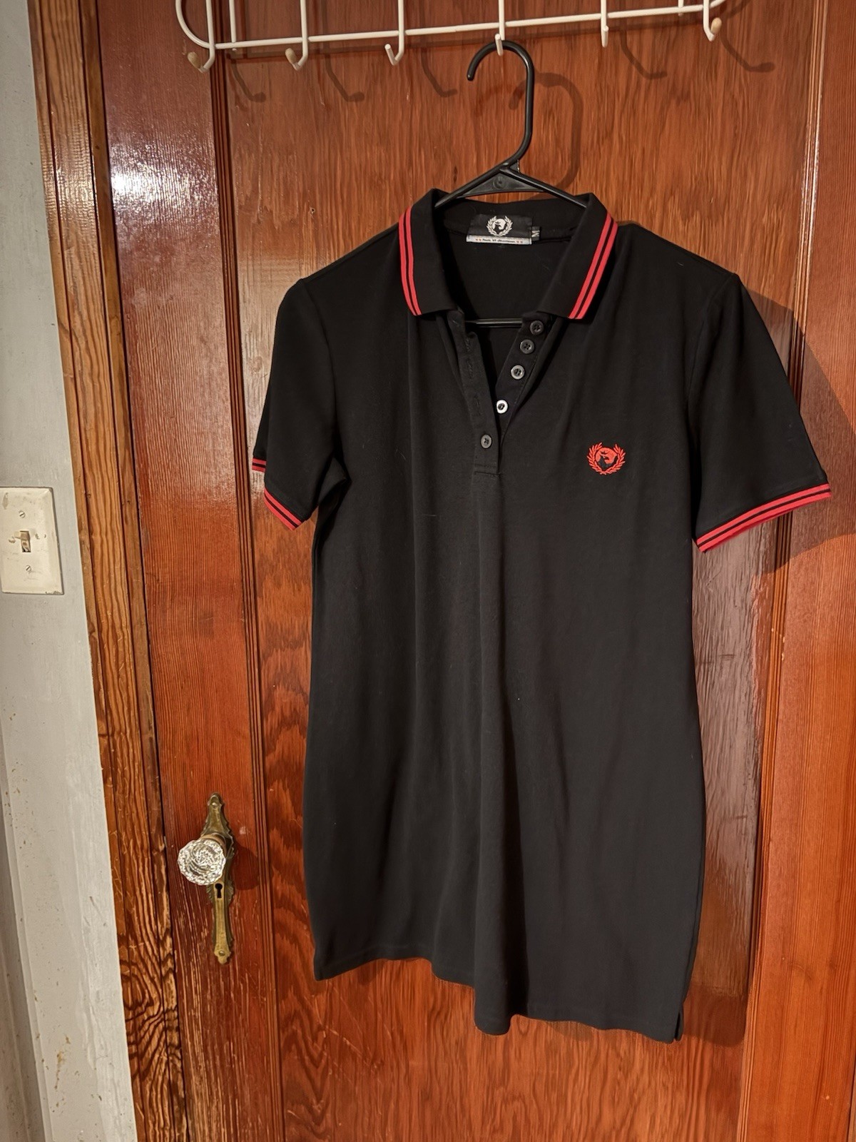 Black polo dress with red piping and logo. Size M