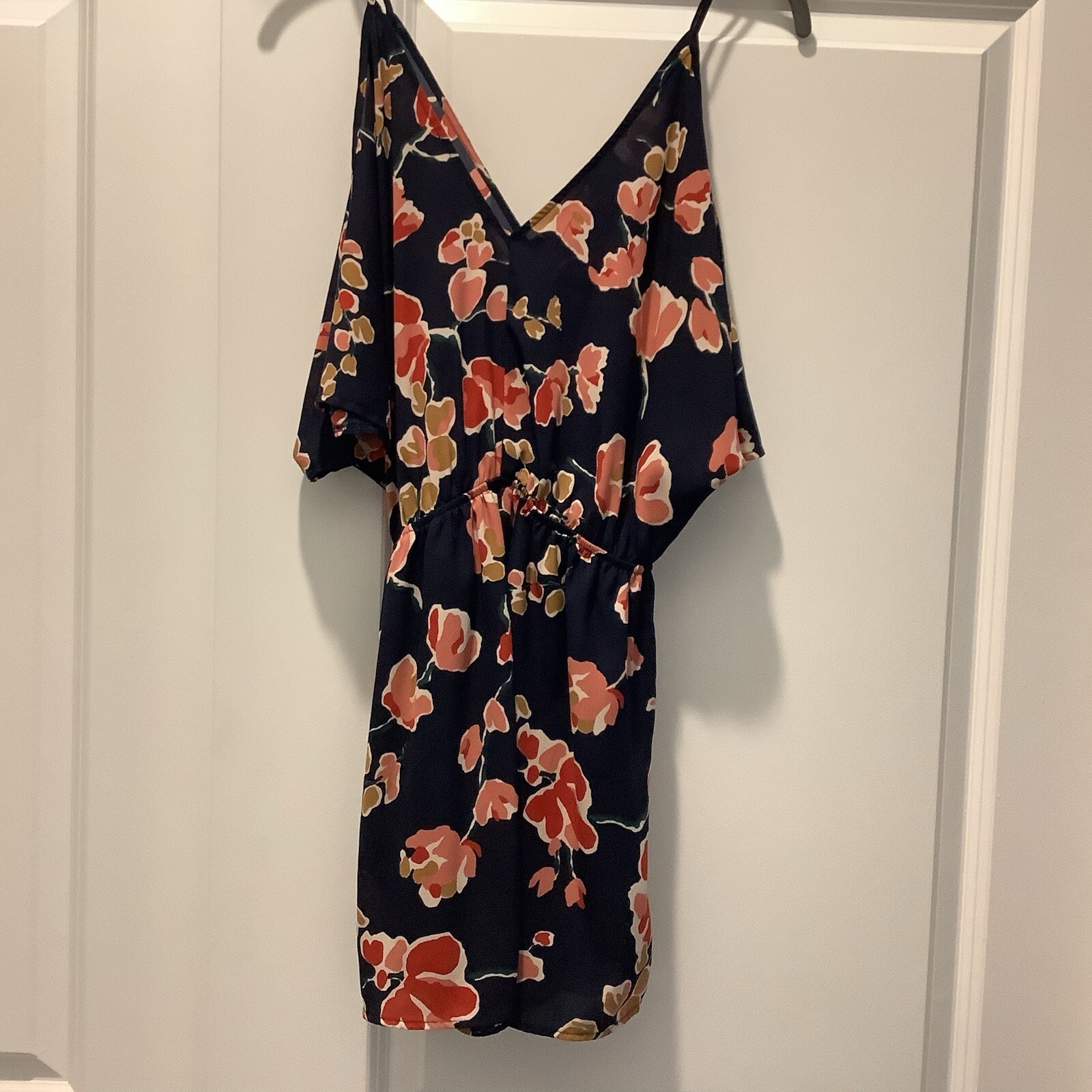 ASTR SUN ROMPER, FLORAL PRINT ON NAVY BACKGROUND, CAN BE WORN CASUAL OR DRESSY.