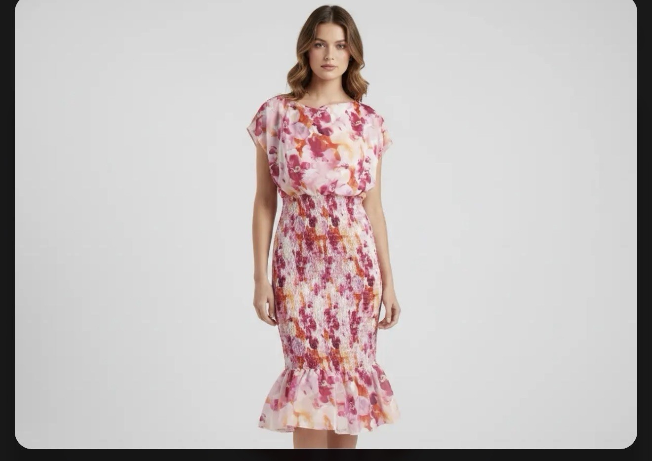 floral-patterned dress featuring a smocked bodice and a ruffled hem