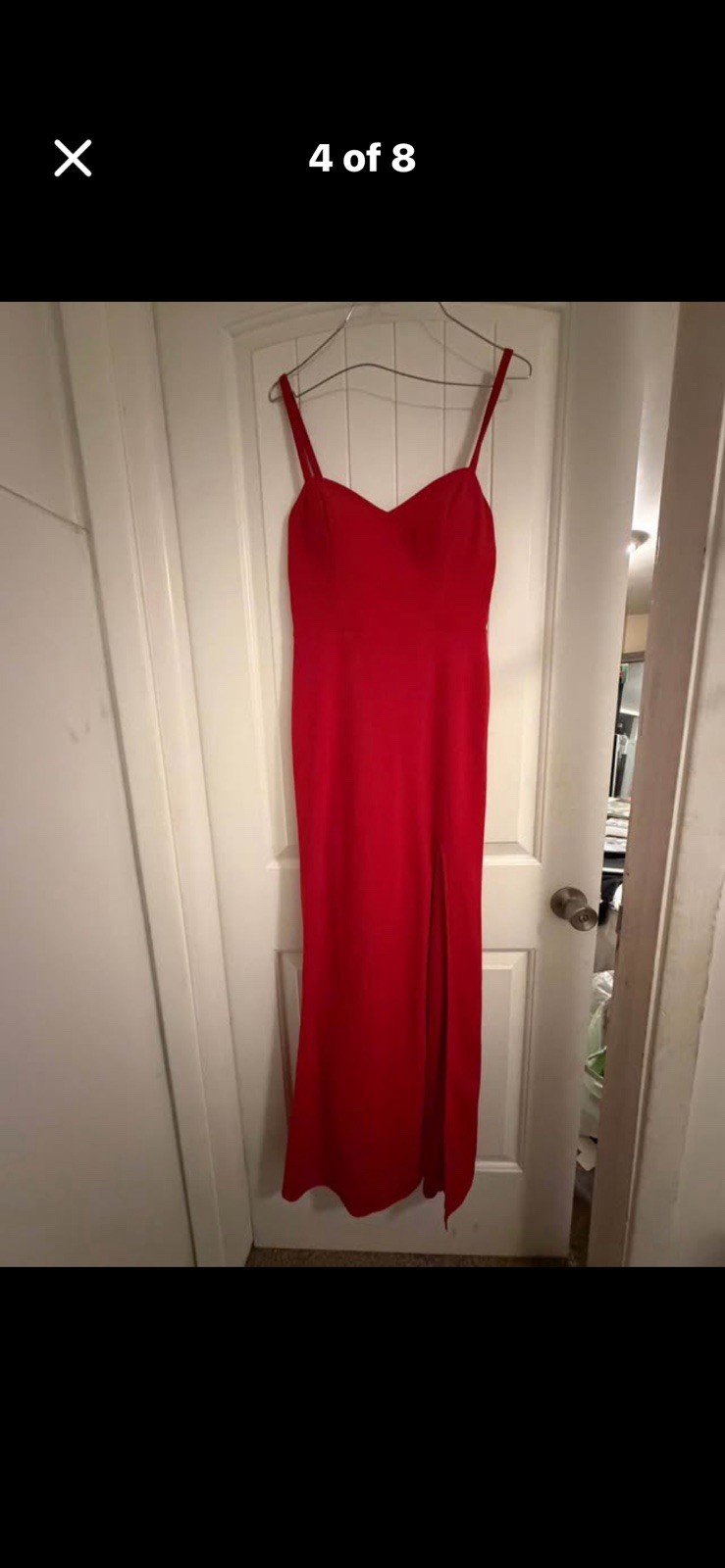 Long red semi-sweetheart neck line with a thigh high slit in the front.