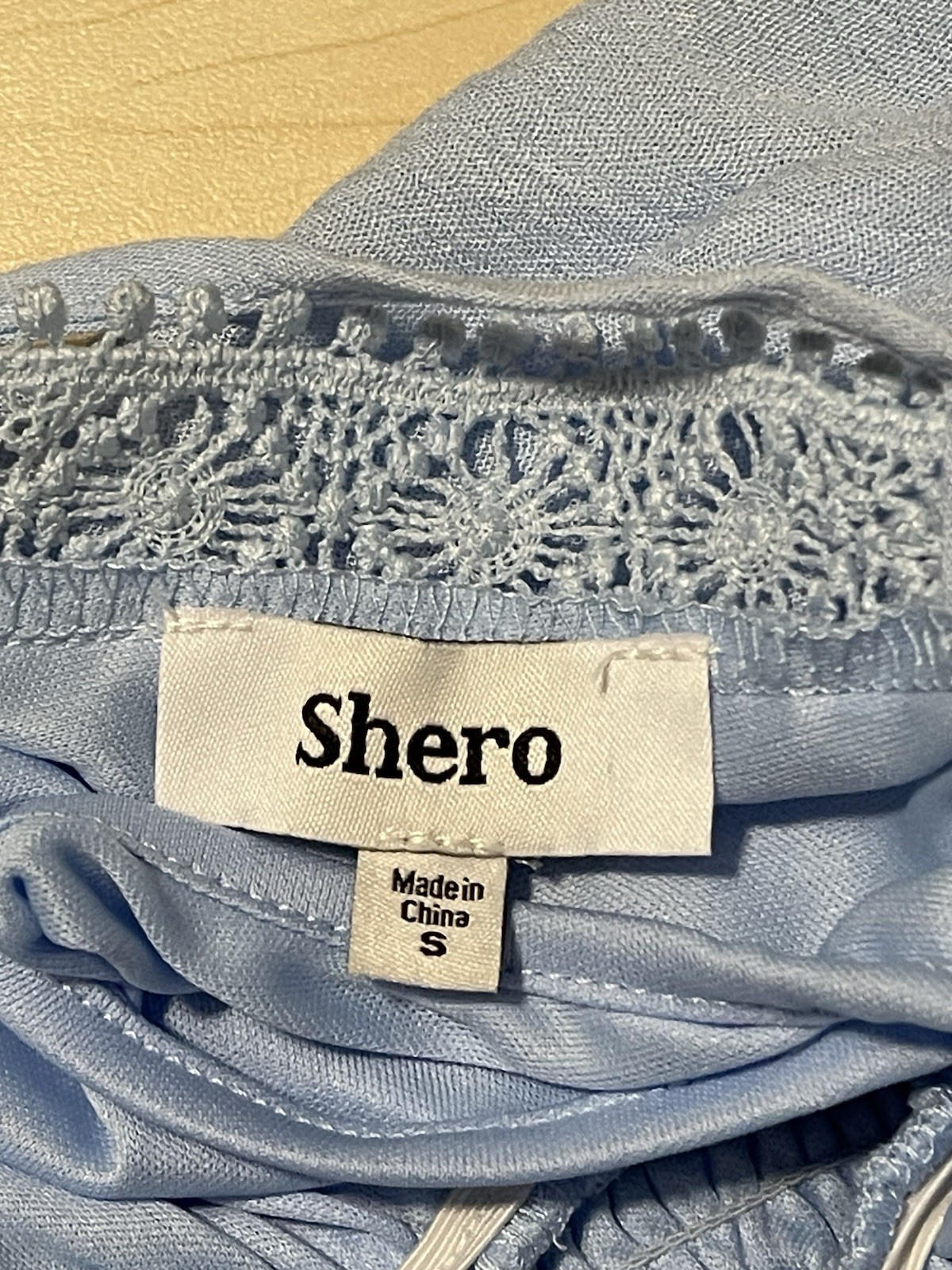2 women’s dresses: one light blue Shero (size S, wide sleeves) and one white