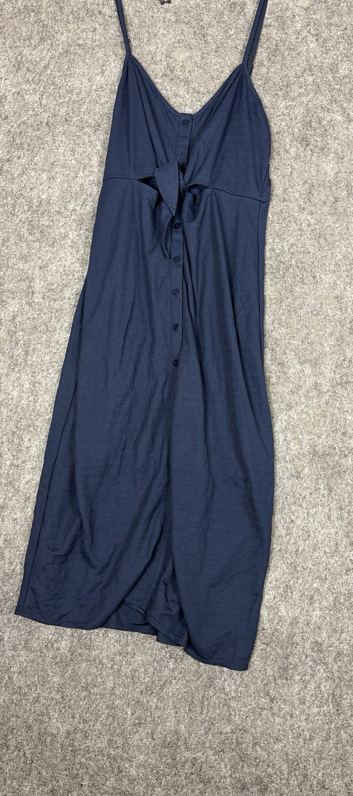 Navy midi dress features a tie-front detail and spaghetti straps.