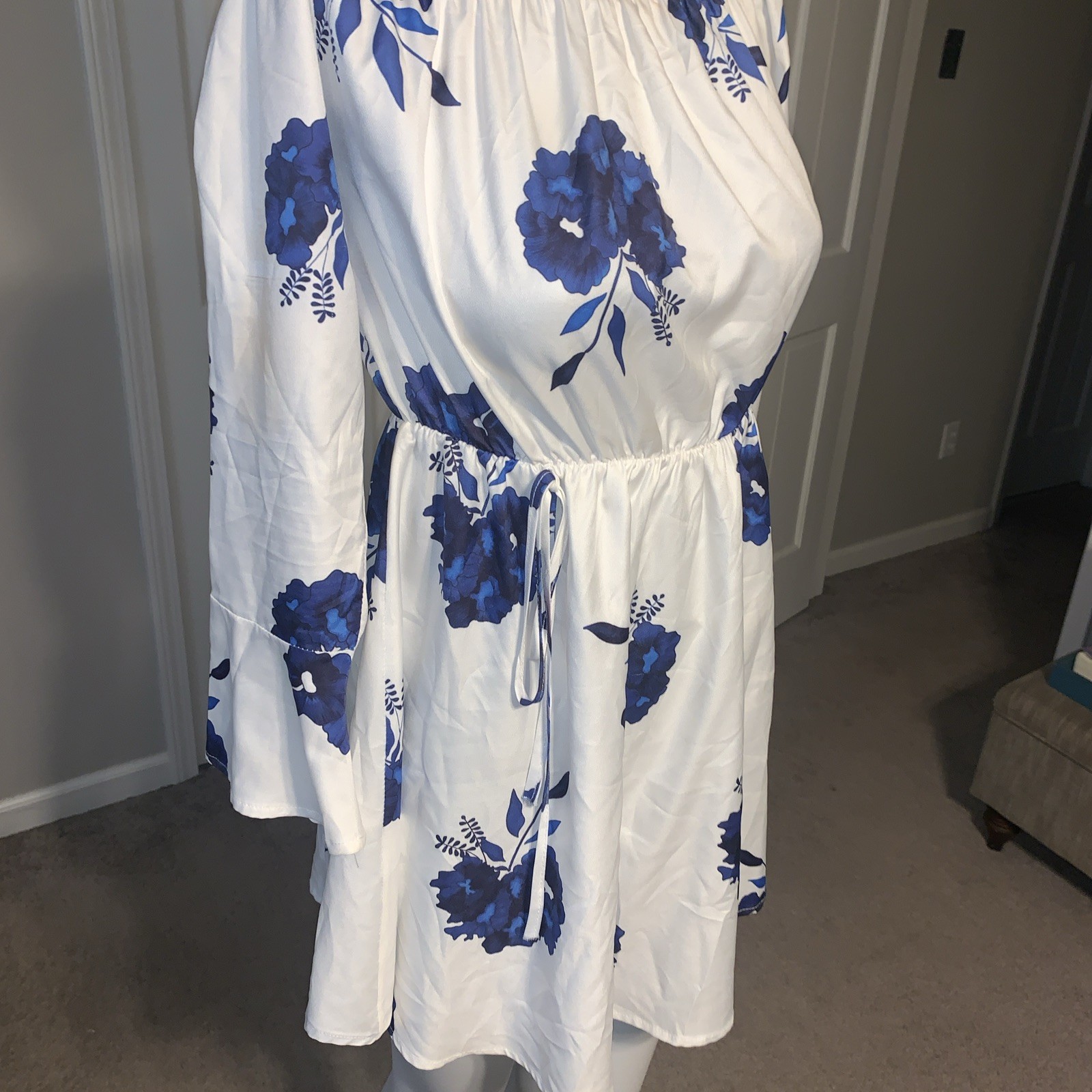 White And Blue Floral Mini Dress With Elastic Neck And Can Be Worn Off Shoulder.