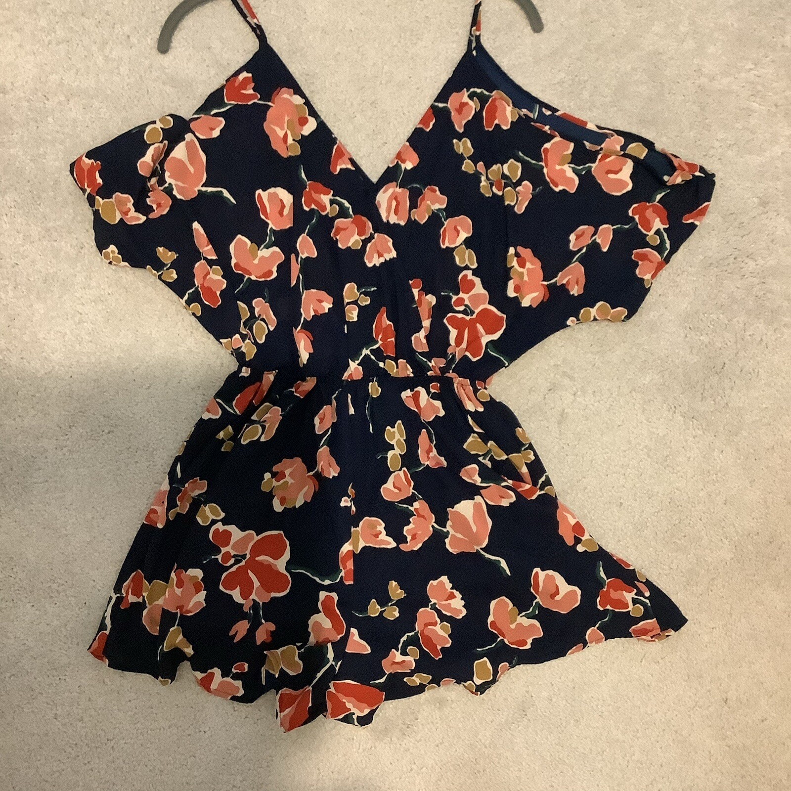 ASTR SUN ROMPER, FLORAL PRINT ON NAVY BACKGROUND, CAN BE WORN CASUAL OR DRESSY.