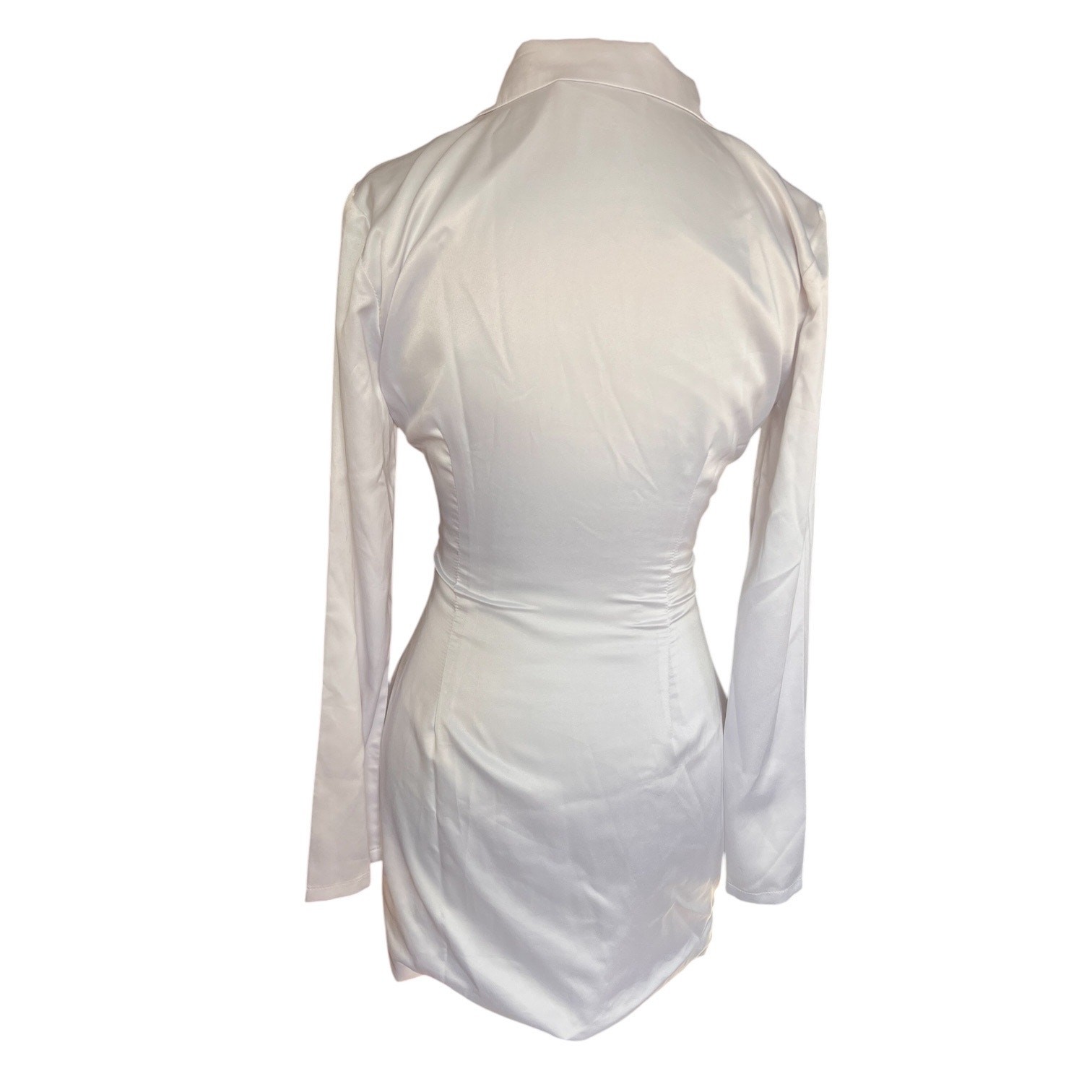 More To Come collared long sleeve mini dress. Tasseled tie belt, snap up, white
