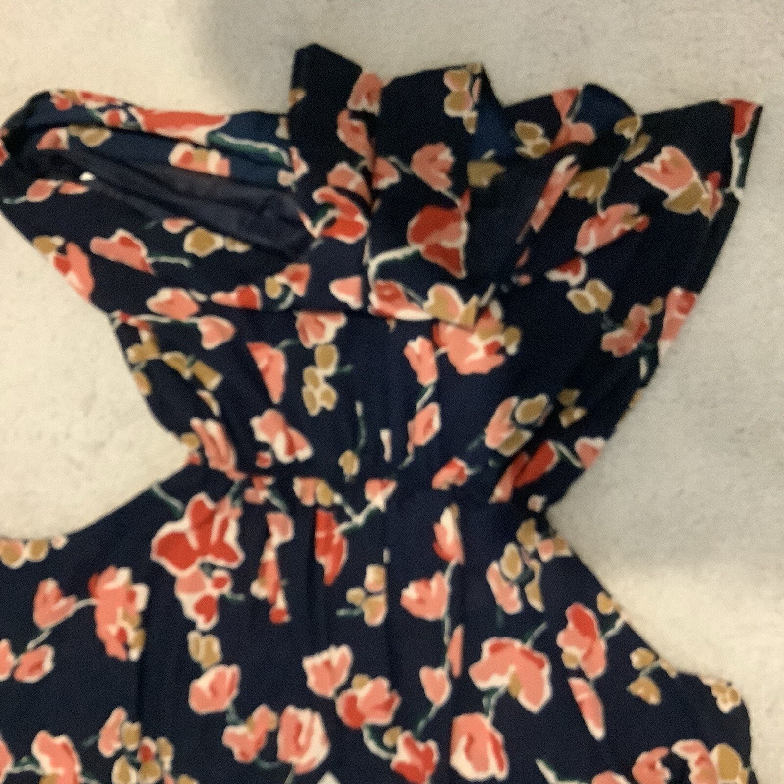 ASTR SUN ROMPER, FLORAL PRINT ON NAVY BACKGROUND, CAN BE WORN CASUAL OR DRESSY.