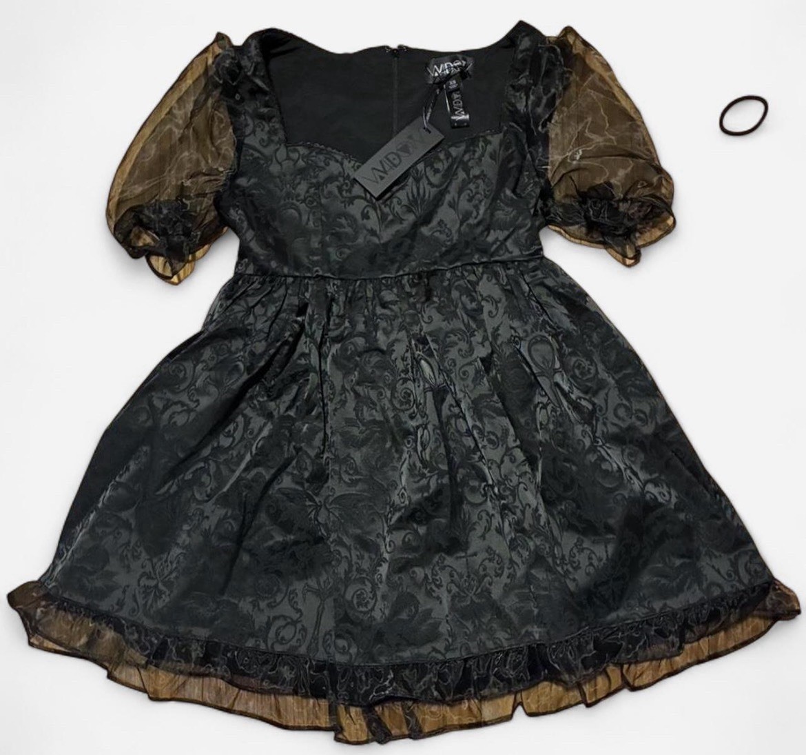 Black lace dress with sheer sleeves and bow detail