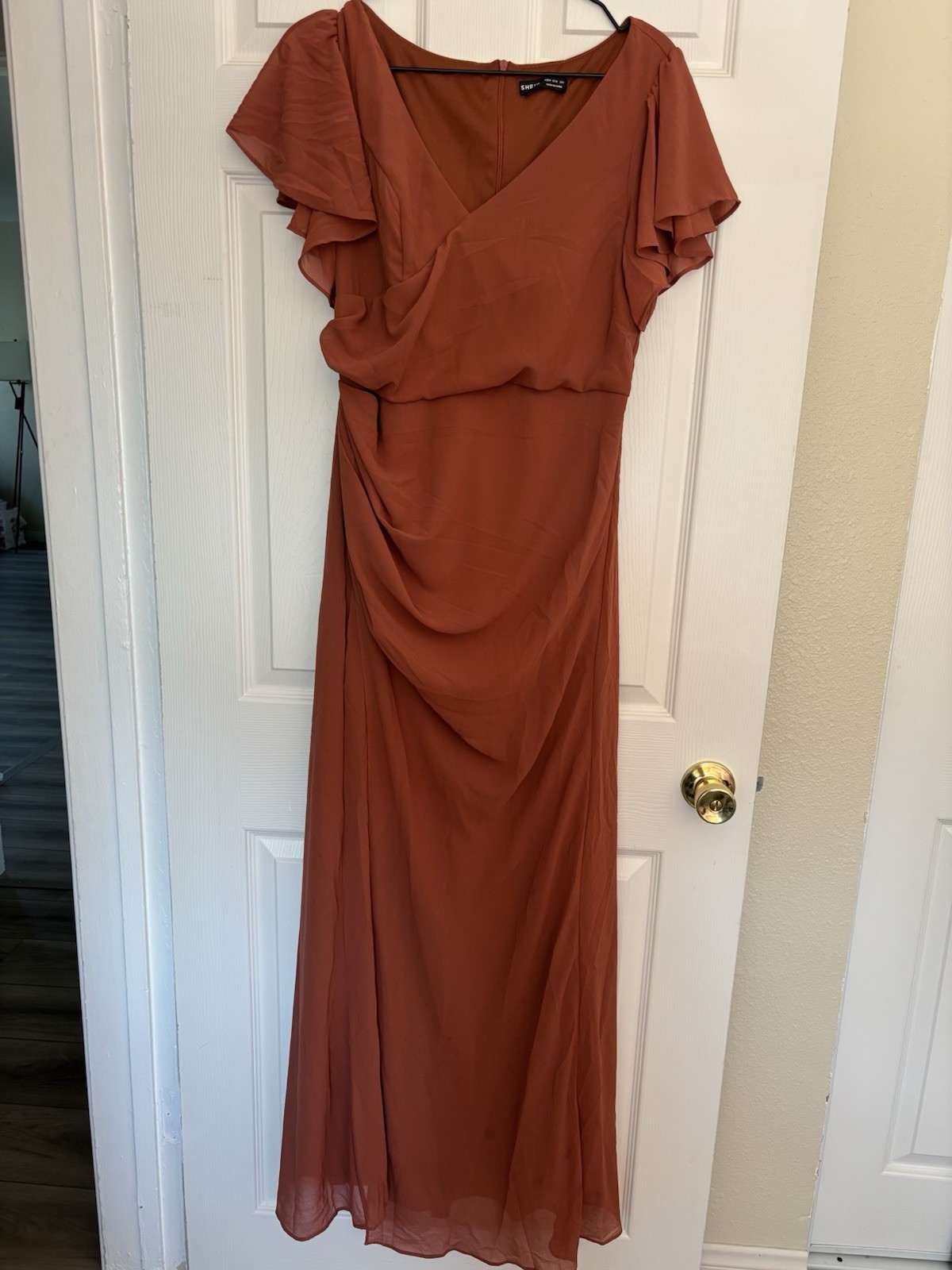 Rust-colored maxi dress with flowy overlay for weddings or fall events.