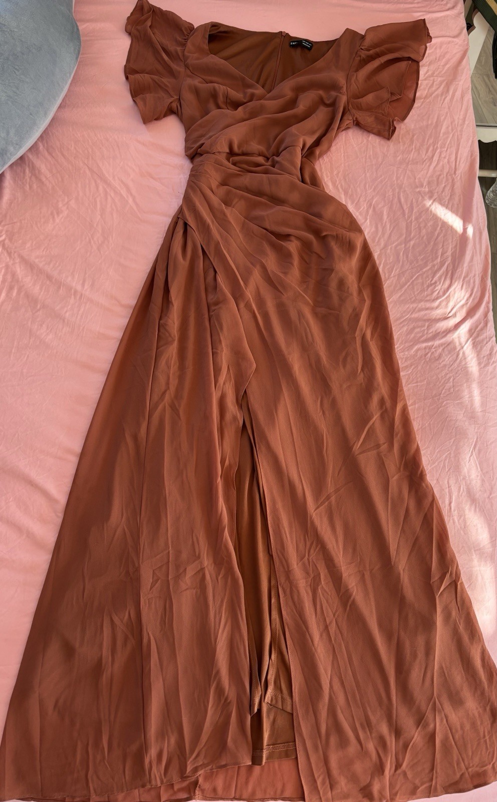 Rust-colored maxi dress with flowy overlay for weddings or fall events.