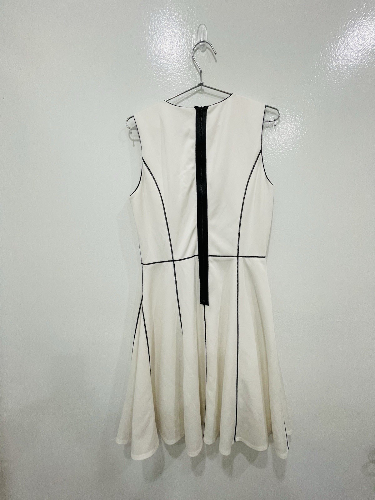 This is a sleeveless A-line dress by Calvin Klein, A Cream Or Off White Color