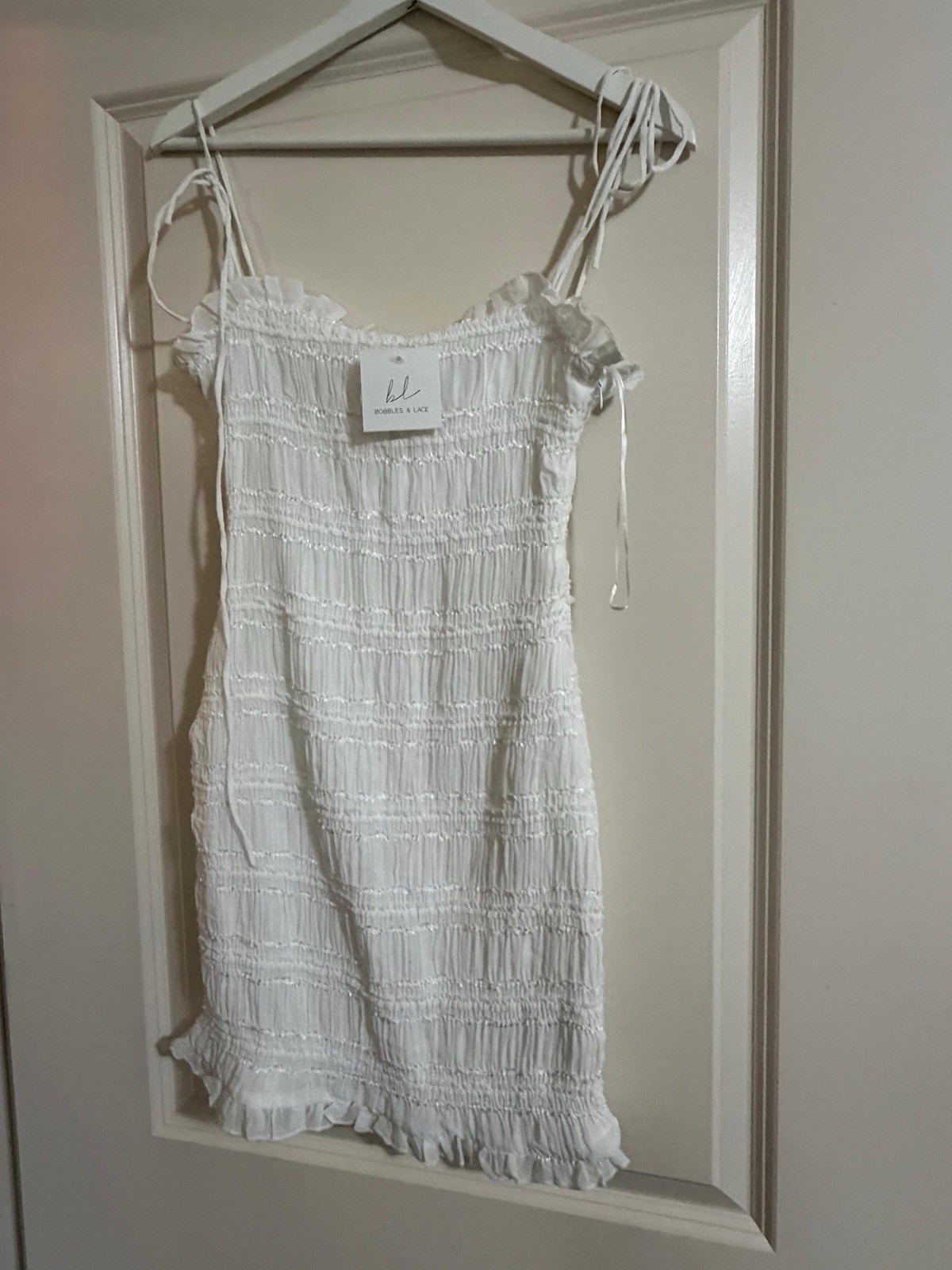 White Smocked Mini Dress Women’s Size L Fits Like S/M Tie Strap Ruffle Hem