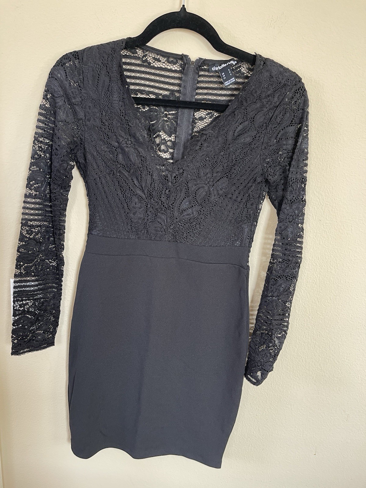 a black lace bodycon dress with long lace sleeves and a V-neckline