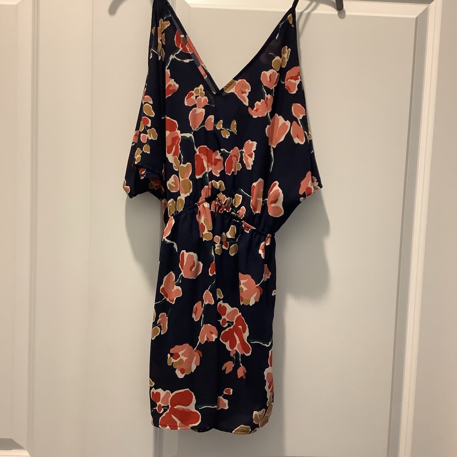 ASTR SUN ROMPER, FLORAL PRINT ON NAVY BACKGROUND, CAN BE WORN CASUAL OR DRESSY.
